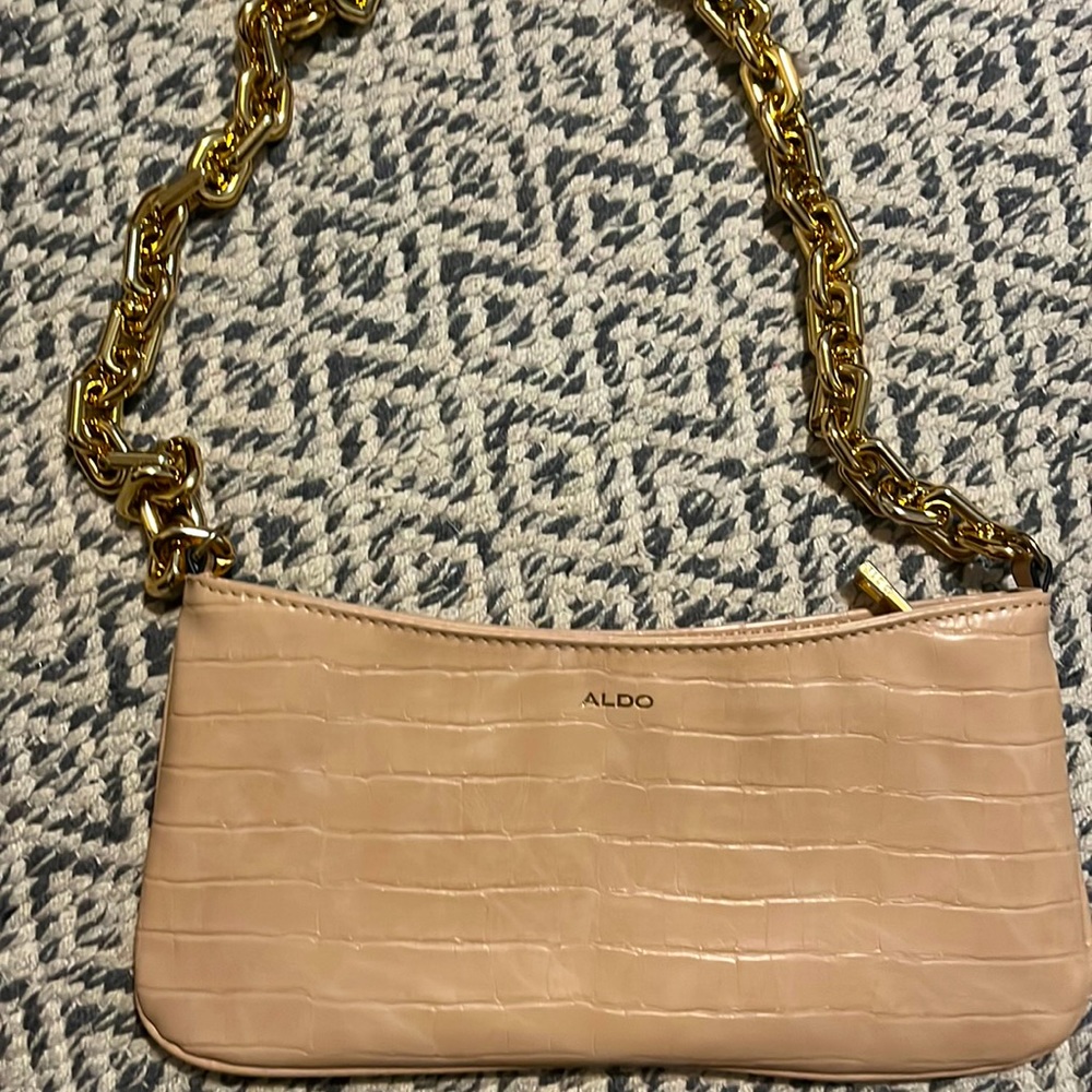 A light color purse, large space inside.